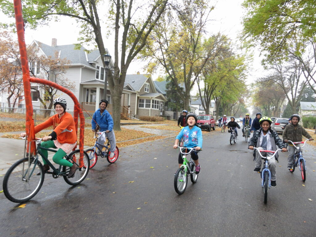 Image of youth biking on a street.