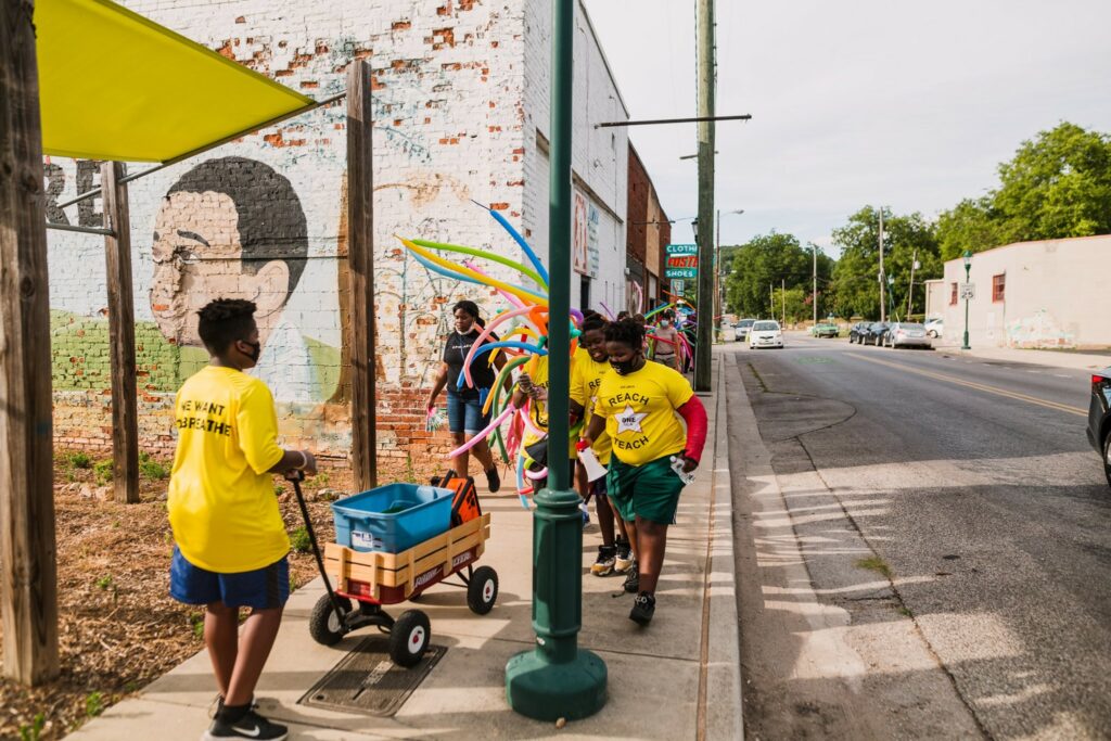 people in yellow shirts walking on chattanooga sidewalk as part of rolling surprise