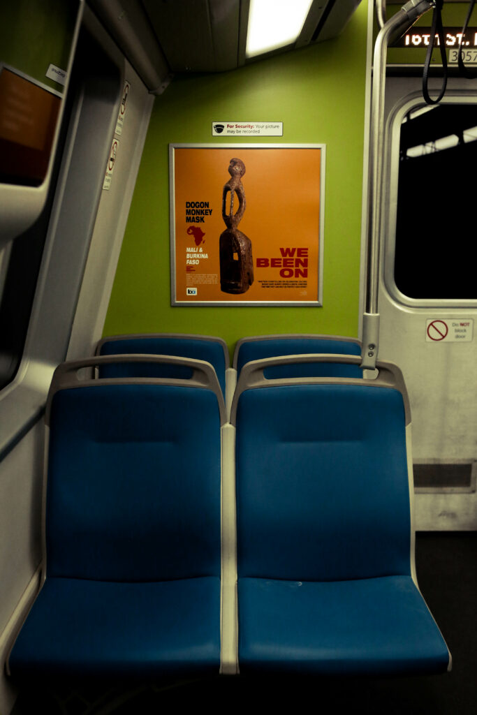 Image of bright orange poster on a green wall of a train.