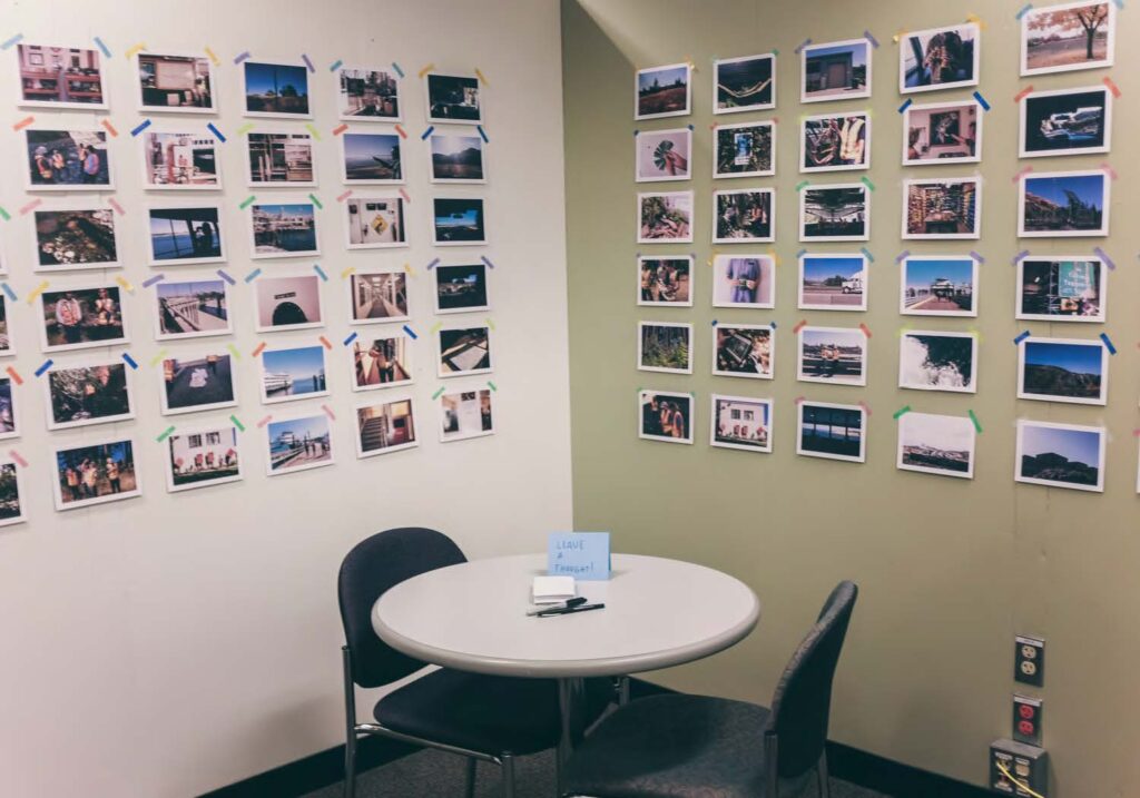 office at WSDOT with a grid of 60 artist photos printed on the walls