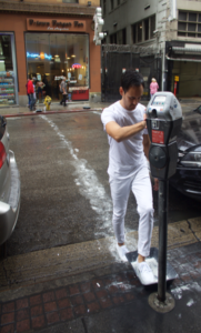 man in all white outfit walking across a street leaving white footprints