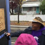 Image of artist and activist Melvin Giles discussing an art piece located on the Green Line in Saint Paul, MN.