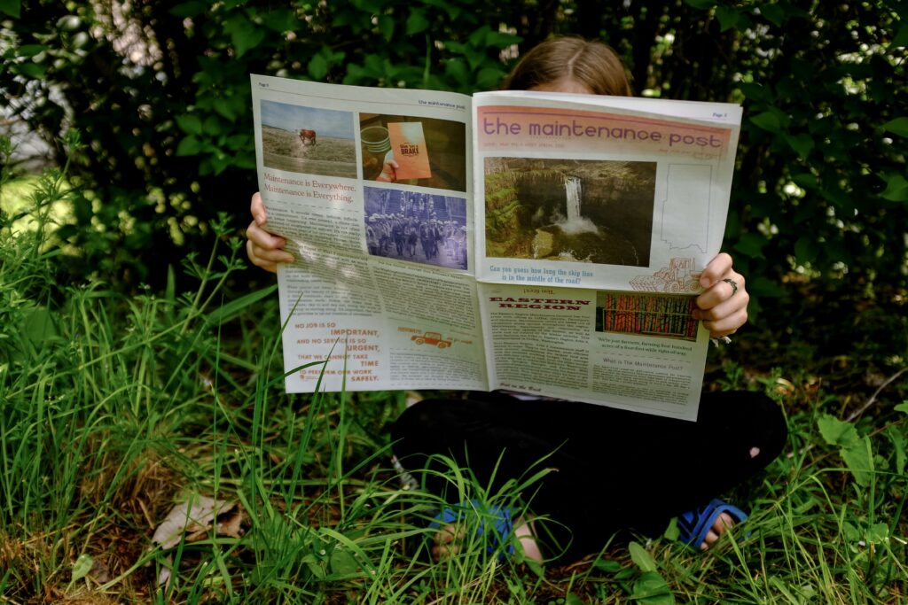 someone reading the maintenance post newspaper