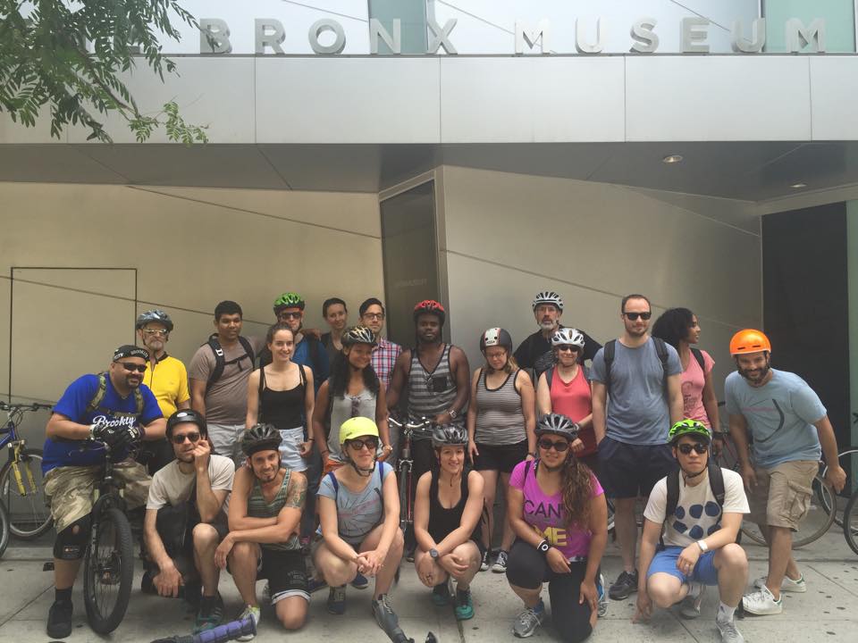 group of bike riders in front of bronx musuem