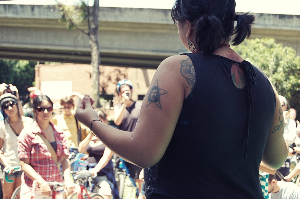 Image of person speaking to crowd of people at Chicano Park.