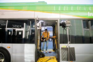 Image of musician performing inside of bus