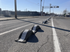 Rubber car tires that have been transformed into bike lane barriers, positioned along a street in Memphis. Photo from Bike Ped Memphis.